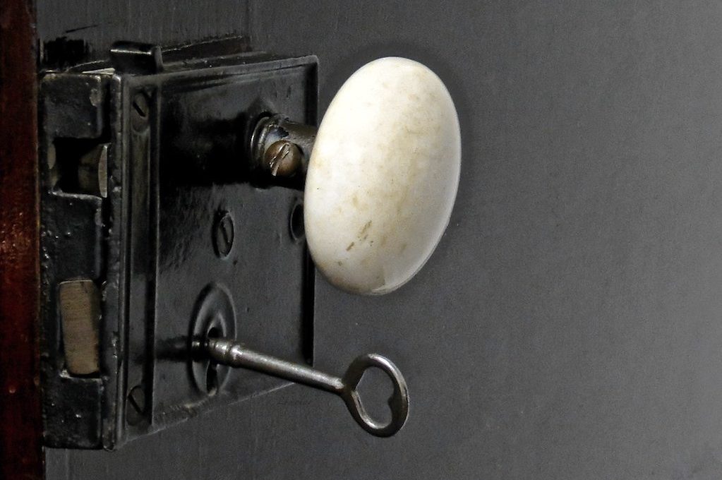 photo of door knob with key inserted